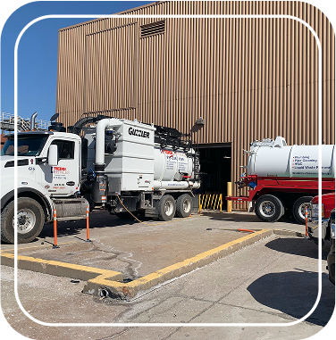Reddi Services Industries trucks parked outside a large building